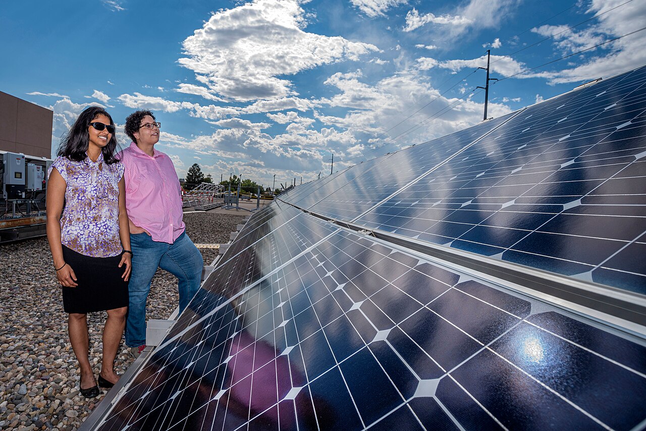 Sandia National Laboratories researchers Thushara Gunda, front, and Nicole Jackson examine solar panels at Sandia’s Photovoltaic Systems Evaluation La